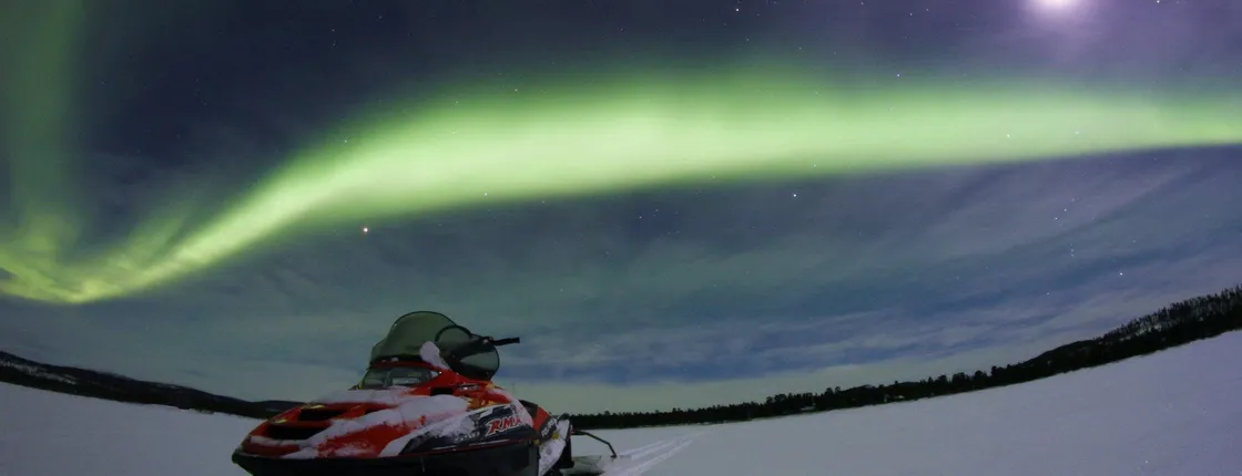 Northern lights hunt by snowmobile