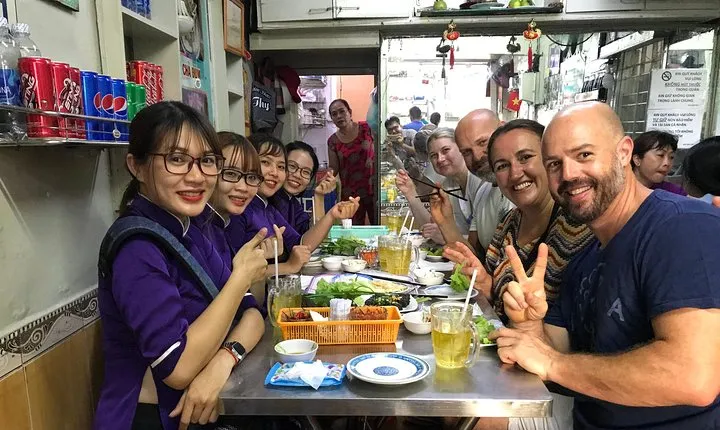 Private Ho Chi Minh Street Food Tour by Motorbike with Ao Dai Female Rider