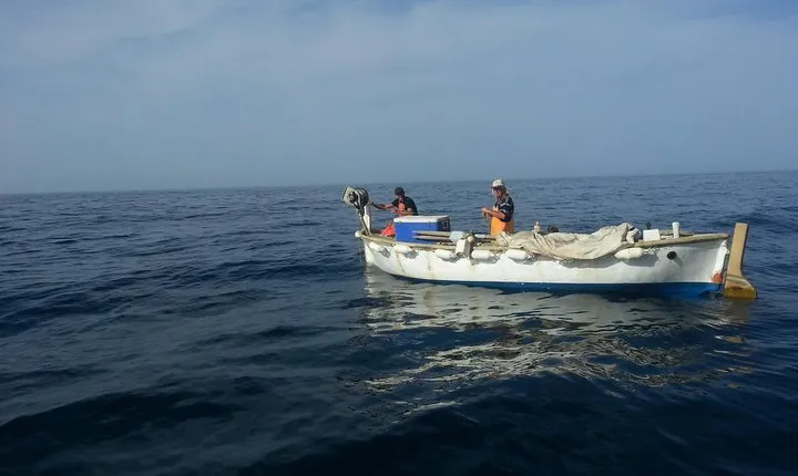 Fishing on Traditional Dubrovnik Fishing Boat in Front of Old City Walls