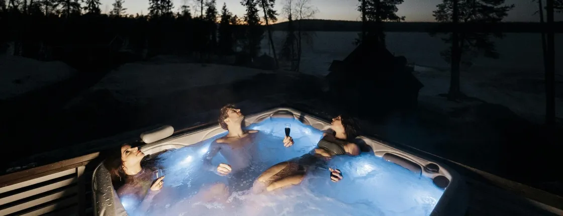 Arctic forest sauna and hot tub experience with northern lights