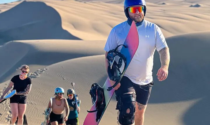Professional sandskiing and sandboarding on the dunes of Huacachina