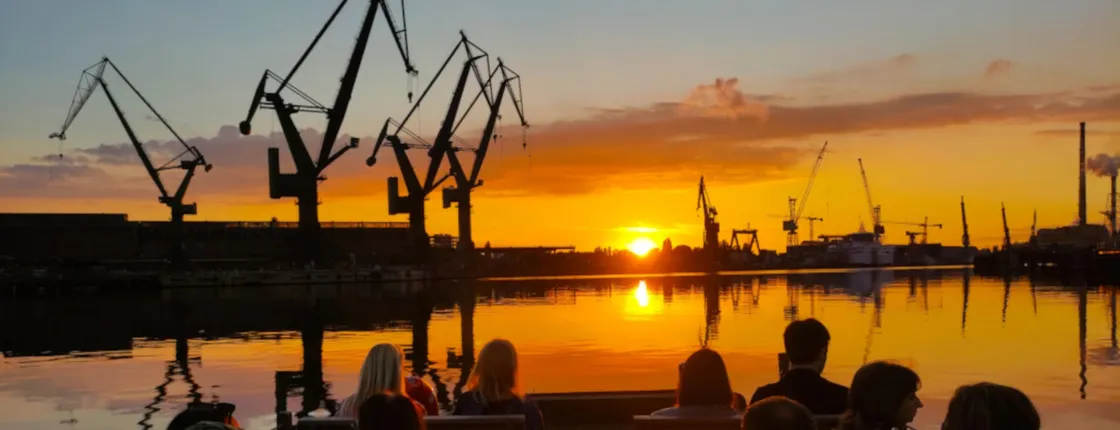 Sunset on the shipyard and old town cruise in Gdansk