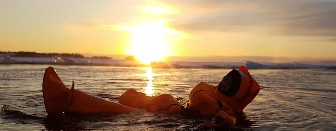 Midnight sun floating experience in forest lake