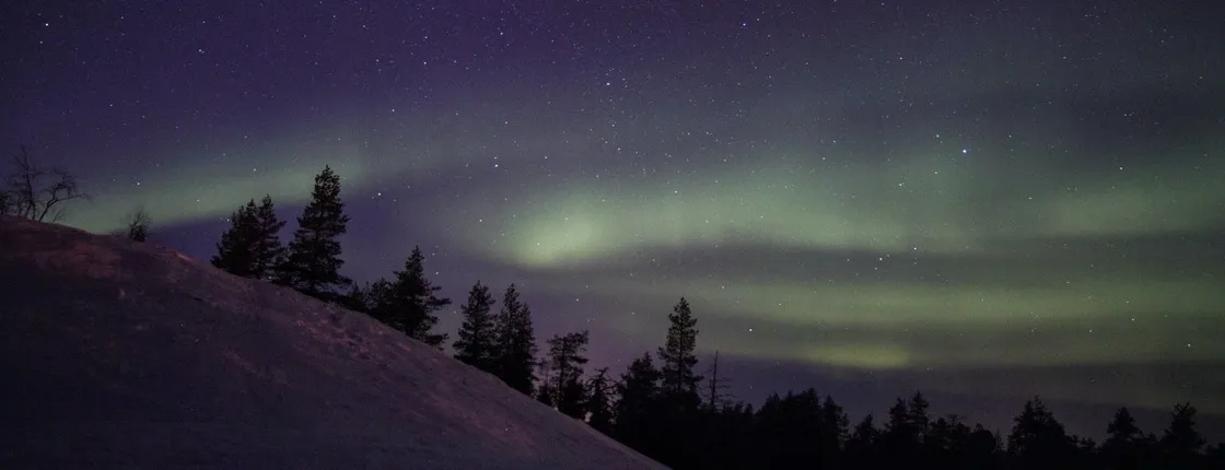 Northern lights hunting by car with campfire