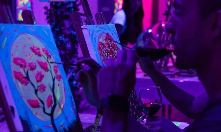 Paint a neon fluorescent picture while drinking unlimited wine