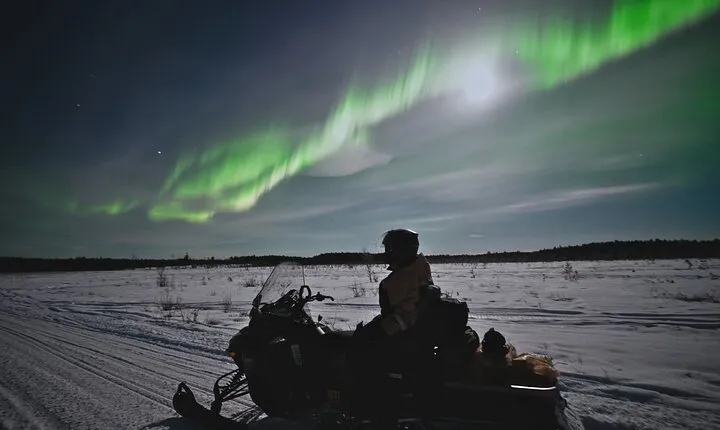 Arctic Aurora Chase by Snowmobile