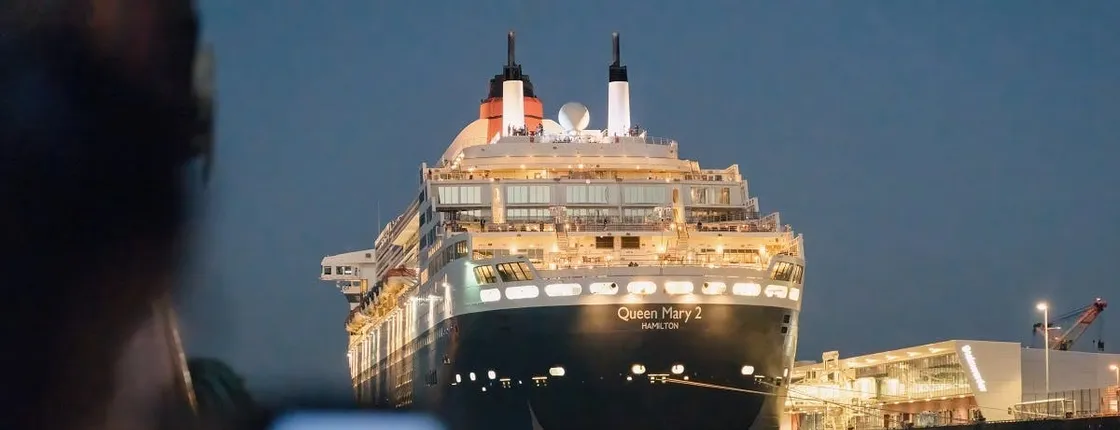 Hamburg evening lights cruise with a large ship