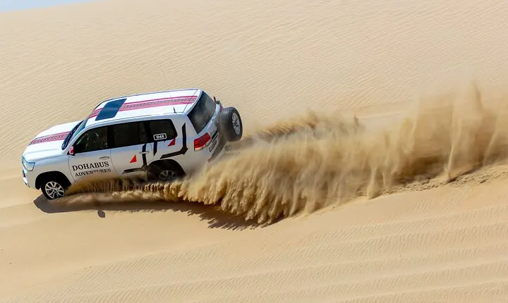 Full-day Qatar desert safari: dune bashing, sandboarding, camels
