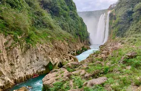 Tamul waterfall and water cave on a wooden canoe