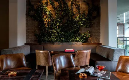 Royalton Park Avenue _ ROOFTOP_ Park Ivy Lounge Small Table With Ivy Wall